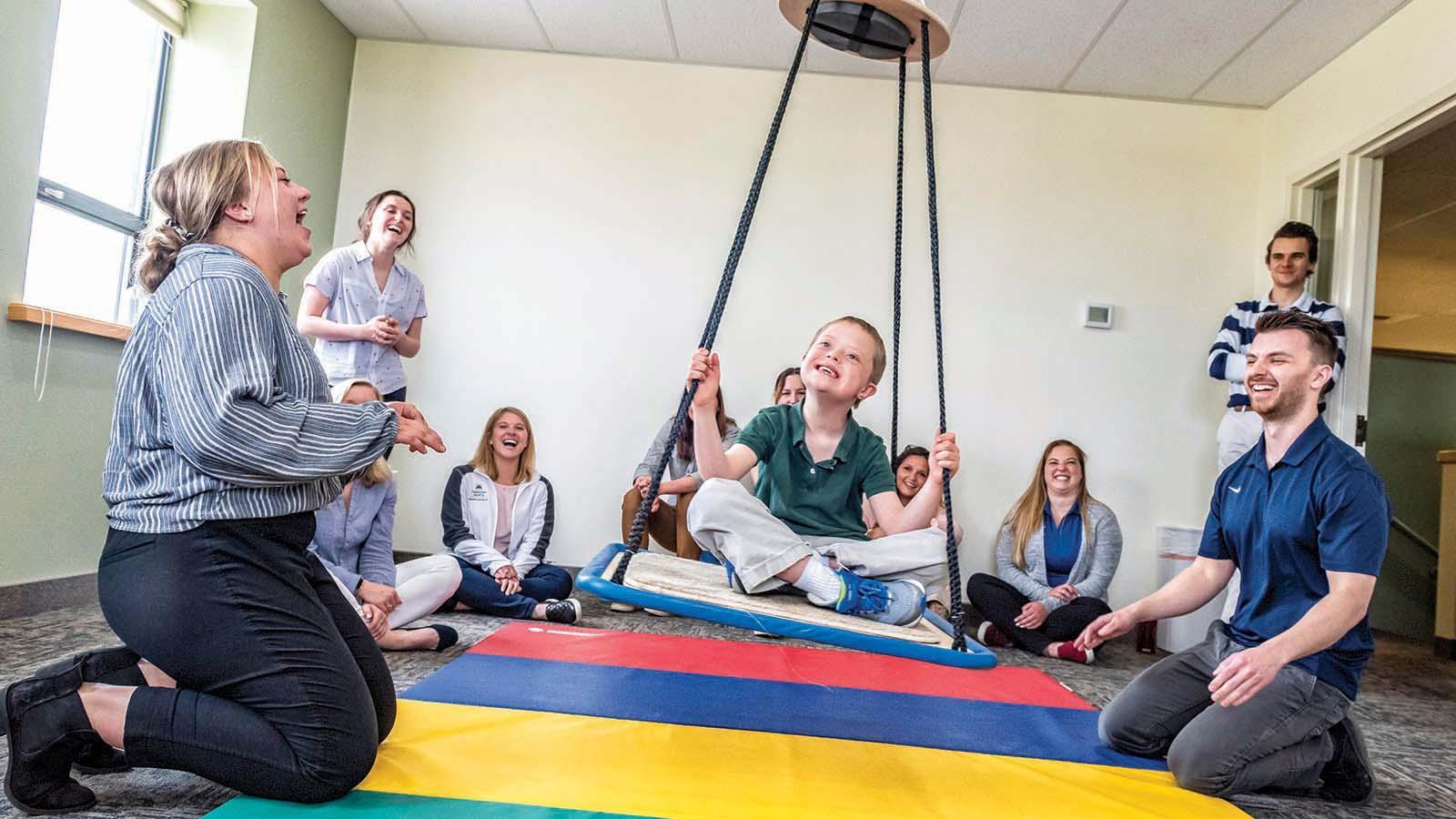 OT students in pro bono clinic with a child patient